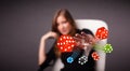 Young woman throwing dices and chips Royalty Free Stock Photo