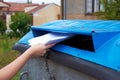 Young woman throwing paper documents into a container for sorted