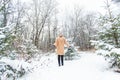 Young woman throwing snow in the air at sunny winter day, she is happy and fun. Royalty Free Stock Photo