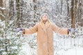 Young woman throwing snow in the air at sunny winter day, she is happy and fun. Royalty Free Stock Photo