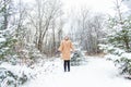 Young woman throwing snow in the air at sunny winter day, she is happy and fun. Royalty Free Stock Photo