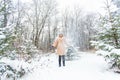 Young woman throwing snow in the air at sunny winter day, she is happy and fun. Royalty Free Stock Photo