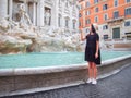 Young woman throws a coin in the Trevi fountain, Rome, Italy Royalty Free Stock Photo