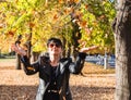 Young woman throws up yellow leaves in the park in autumn Royalty Free Stock Photo