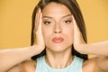 A young woman tightens her face with her hands Royalty Free Stock Photo