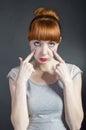 Young woman with tired eyes on black background. Negative facial Royalty Free Stock Photo