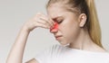 Sad woman holding nose because sinus pain Royalty Free Stock Photo
