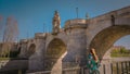 A young woman at Toledo medieval bridge at Madrid Rio park in Spain Royalty Free Stock Photo