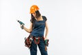 Young woman with toolbelt using driil and some power tools for her work at home. Girl working at flat remodeling. Building, repair Royalty Free Stock Photo