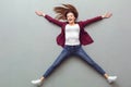 Young woman top view on grey lying on floor cheerful