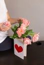 Young woman touches a bouquet presented to her. Spring flowers and greeting card Royalty Free Stock Photo