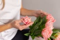 Young woman touches a bouquet presented to her. Spring flowers and greeting card Royalty Free Stock Photo