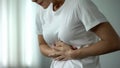 Young woman touching belly, suffering from sharp stomach ache, gastritis, health Royalty Free Stock Photo
