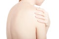 Young woman touching her painful shoulder, clipping path