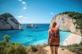 Young woman tourist with backpack standing on the edge of cliff in Zakynthos island, Greece, Young woman with backpack on the Royalty Free Stock Photo