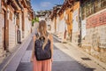 Young woman tourist in Bukchon Hanok Village is one of the famous place for Korean traditional houses have been Royalty Free Stock Photo