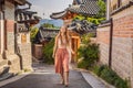 Young woman tourist in Bukchon Hanok Village is one of the famous place for Korean traditional houses have been Royalty Free Stock Photo