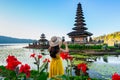 Young woman tourist enjoying the beautiful view at Ulun Danu Beratan temple in Bali, Indonesia Royalty Free Stock Photo