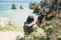 A young woman tourist enjoys beautiful views of the Atlantic Ocean and the landscape. Royalty Free Stock Photo