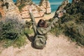 A young woman tourist enjoys beautiful views of the Atlantic Ocean and the landscape. Royalty Free Stock Photo