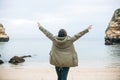 A young woman tourist enjoys beautiful views of the Atlantic Ocean and the landscape. Royalty Free Stock Photo