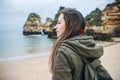 A young woman tourist enjoys beautiful views of the Atlantic Ocean and the landscape. Royalty Free Stock Photo