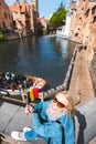 A young woman with the flag of Belgium in her hands is enjoying the view of the canals in the historical center of Royalty Free Stock Photo