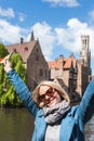 A young woman with the flag of Belgium in her hands is enjoying the view of the canals in the historical center of Royalty Free Stock Photo