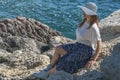 Woman tourist sitting on the sea front Royalty Free Stock Photo