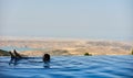 Young Woman tourist in infinity pool Royalty Free Stock Photo