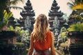 Young woman tourist in balinese temple, Bali island, Indonesia. Generative AI