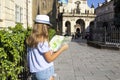 Young woman tourist looking at map, girl visit in old town of Prague, Czech Republic