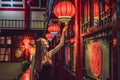 Young woman tourist looks at the Chinese traditional lanterns. Chinese New Year. Travel to China concept Royalty Free Stock Photo