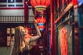 Young woman tourist looks at the Chinese traditional lanterns. Chinese New Year. Travel to China concept Royalty Free Stock Photo