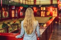 Young woman tourist looks at the Chinese traditional lanterns. Chinese New Year. Travel to China concept Royalty Free Stock Photo