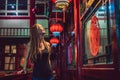 Young woman tourist looks at the Chinese traditional lanterns. Chinese New Year. Travel to China concept Royalty Free Stock Photo