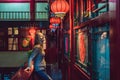 Young woman tourist looks at the Chinese traditional lanterns. Chinese New Year. Travel to China concept Royalty Free Stock Photo