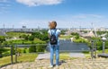 Young woman tourist looks at Olympic park in summer, Munich, Germany