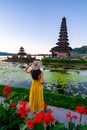 Young woman tourist relaxing and enjoying the beautiful view at Ulun Danu Beratan temple in Bali Royalty Free Stock Photo