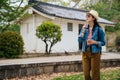 Young woman tourist searching the destination on online map app and finding around. elegant traveler with slr camera looking up to