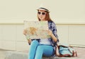 Young woman tourist sightseeing city with paper map Royalty Free Stock Photo