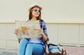 Young woman tourist sightseeing city with paper map Royalty Free Stock Photo