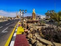 Young woman tourist sits on the stones against the background of Old Market in Sharm El Sheikh Egypt. Adult girl rests on the Royalty Free Stock Photo