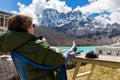 Young woman tourist sitting resting infront mountains ridge view