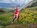 Young woman tourist standing on cliff`s edge Royalty Free Stock Photo