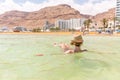 Young woman tourist swimming floating salty water, Dead sea. Royalty Free Stock Photo