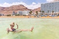 Young woman tourist swimming floating salty water, Dead sea. Royalty Free Stock Photo