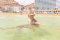 Young woman tourist swimming floating salty water, Dead sea. Royalty Free Stock Photo