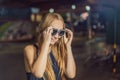 Young woman tourist trying on glasses on Walking street Asian market