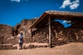 Young woman tourist walking around the Pisac ruins